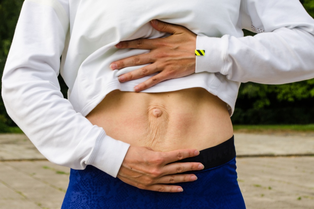 Woman holding stomach